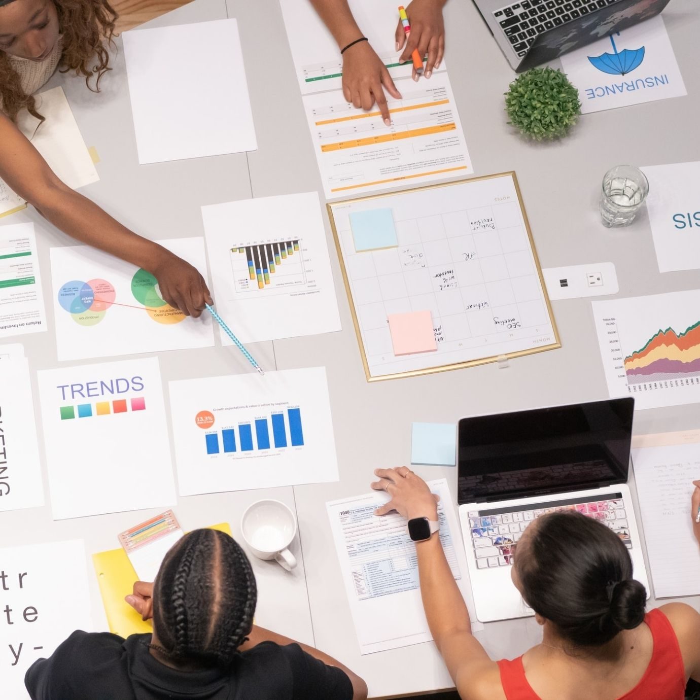 documents on a table and people discussing them
