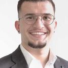 smiling man with glasses and suit